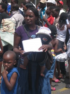 Mother and children waiting in long ZDP queue